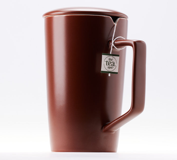 
                  
                    a brown ceramic tea mug with a notch for a tea bag that is wrapped around the handle
                  
                
