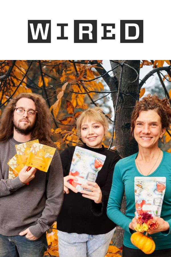Wired magazine-three people stand holding tea in front of fall trees