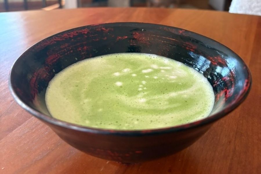 a bowl of matcha whisked in a bowl