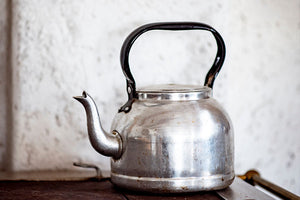 a tea kettle sits on a stove top waiting to be descaled
