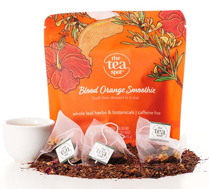 tea bags sit in front of an orange bag that reads blood orange smoothie tea