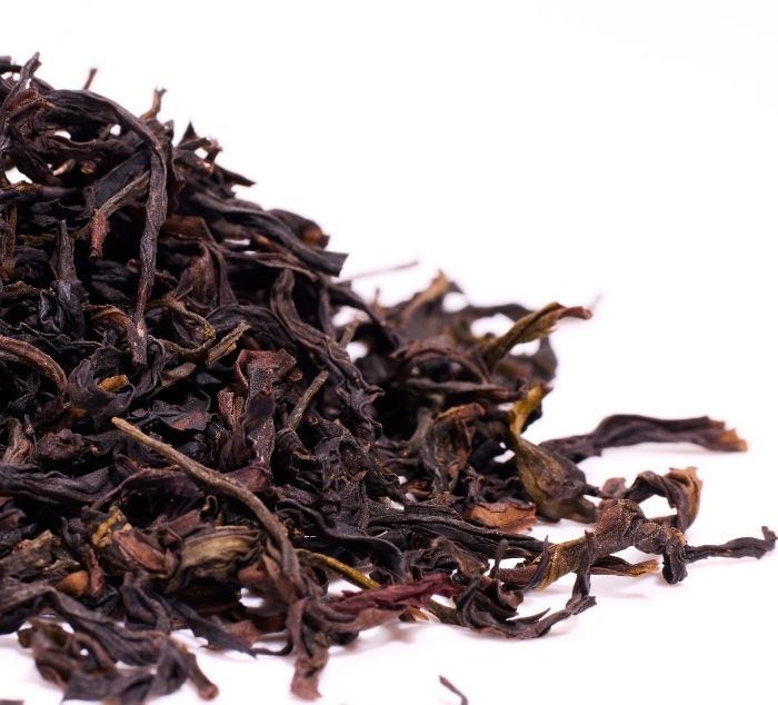 Dried mi lan xiang oolong tea leaves on a white background