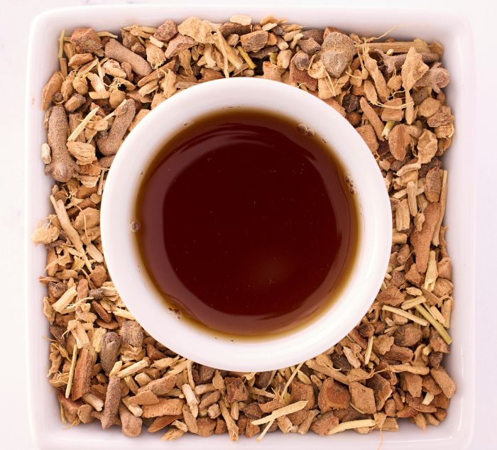 
                  
                    adaptogen reset herbal tea brewed in a cup surrounded by loose leaf adaptogen reset
                  
                