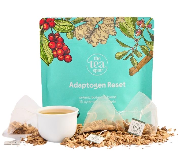 Tea package labeled 'Adaptogen Reset' with tea bags and loose tea on a white background