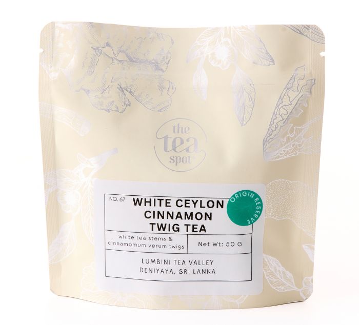 A 50g stand-up pouch of The Tea Spot White Ceylon Cinnamon Twig Tea, featuring a cream-colored background with light botanical illustrations and a white label.