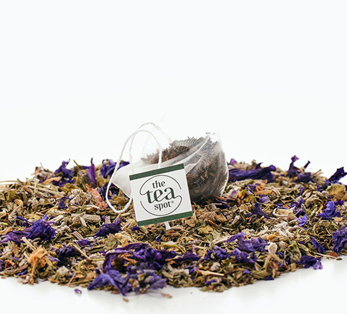 
                  
                    a pile of loose leaf tea with a tea bag on top, all desert sage herbal tea blend
                  
                