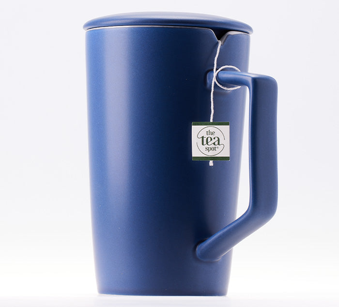 a blue ceramic tea mug with a notch for a tea bag that is wrapped around the handle