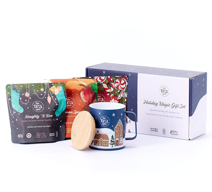 a tea gift set with a mug and three packages of tea stand in front of a box