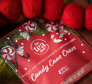 a tea bag in a red wrapper reads candy cane craze, caffeine free holiday tea