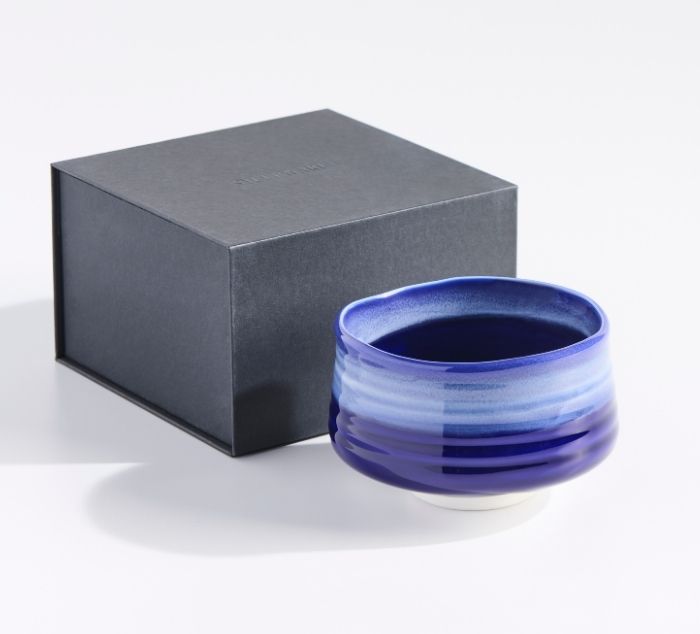 matcha bowl in cobalt blue sits in front of a black box