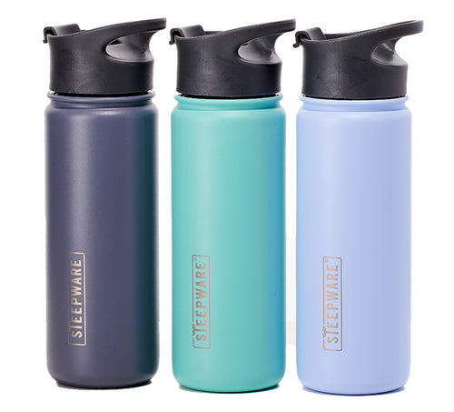 a set of three tumblers, grey, teal, and purple in a row on a white background
