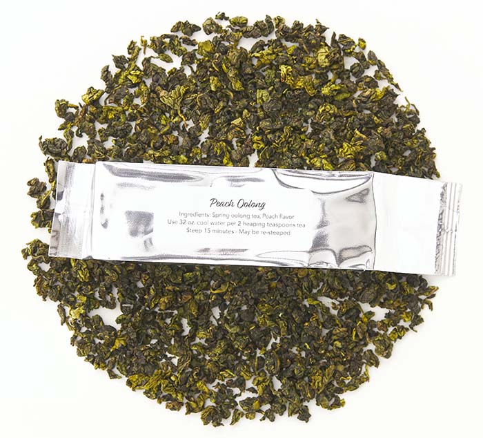 
                  
                    peach oolong loose leaf tea with a silver package on top reading peach oolong
                  
                
