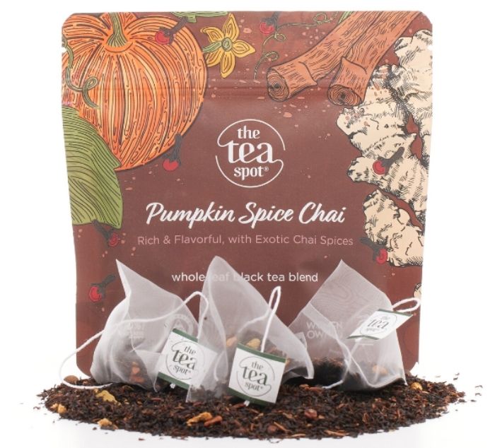 The Tea Spot Pumpkin Spice Chai tea packaging with three tea bags and loose tea leaves displayed in front on a white background.