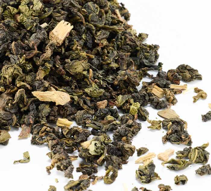 Close-up of loose Sugar Cookie Oolong tea leaves on a white background