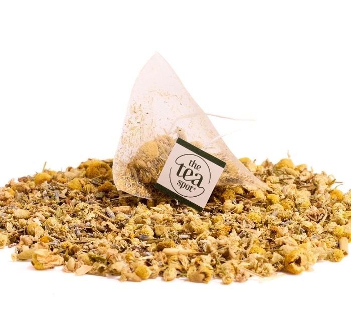 a tea sachet sits on top of loose leaf tea ingredients for sweet dreams tea