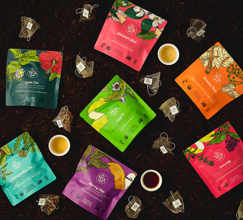 functional botanical tea bags seven pouches of bagged tea sit on a black background with tea bags and tea cups surrounding 