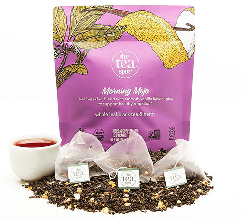 Morning Mojo Tea bags sit on top of loose leaf tea in front of bagged tea reading whole leaf black tea to support healthy digestion