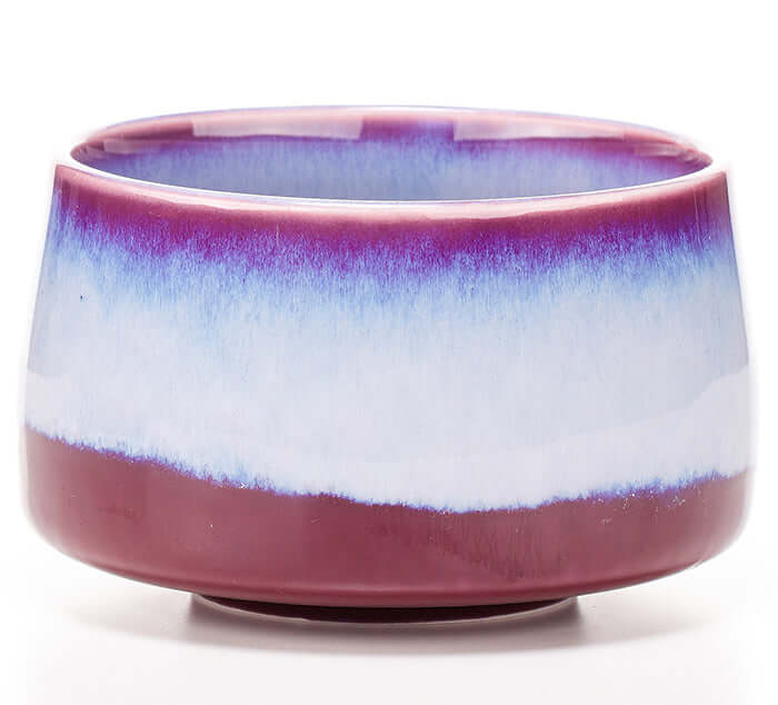 Handcrafted ceremonial matcha bowl with vibrant hues, ideal for tea and loose leaf tea; glazed ceramic with unique color variations.