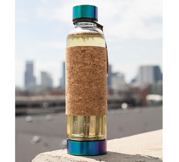 Modern tea tumbler with cork sleeve, ideal for steeping loose leaf tea; features a colorful lid, perfect for tea enthusiasts.